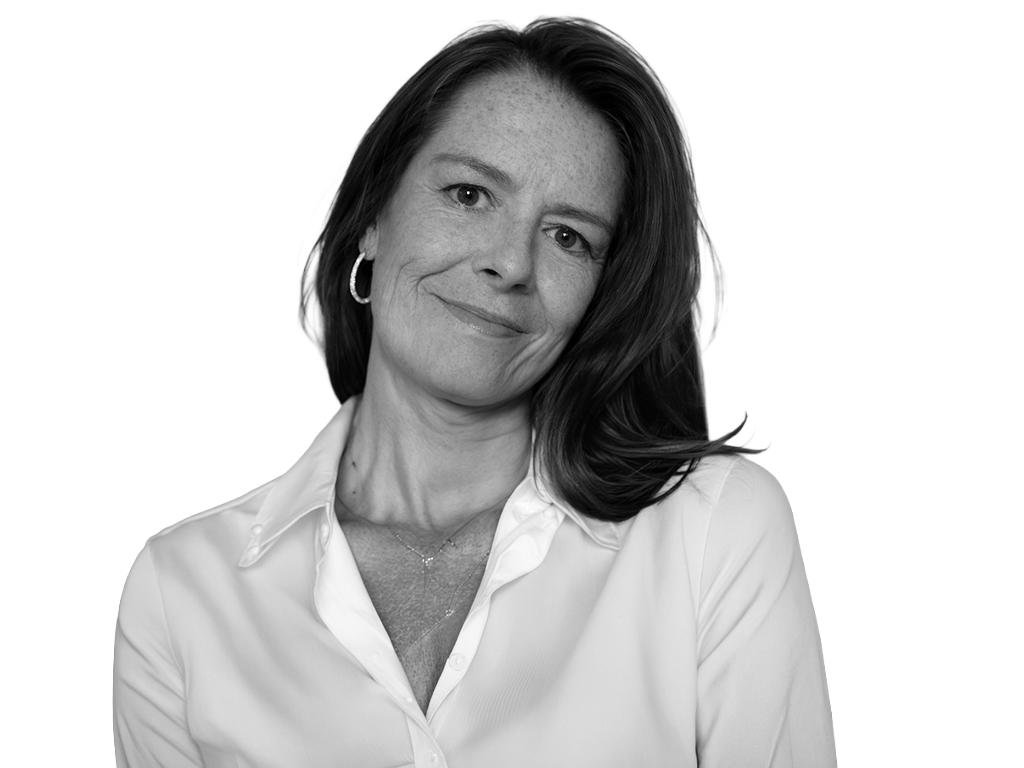 Professional headshot of a smiling woman in a white blouse, looking at the camera.